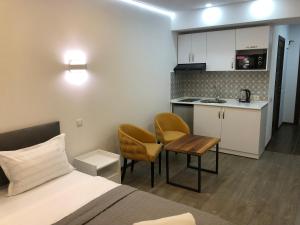 a small room with a bed and a kitchen at panorama beach tower in Batumi