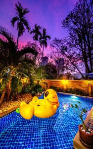 a swimming pool with a blue and yellow pool umbrella at 4poolvillas in Pattaya North