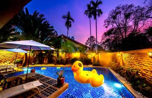 a swimming pool with a rubber duck in the middle at 4poolvillas in North Pattaya