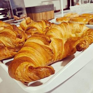a tray of croissants and other pastries on a table at Hotel Cervantes in Sanxenxo