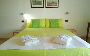 a bedroom with a bed with two towels on it at B&B Andrieddu in Telti
