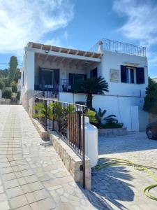 una casa blanca con una valla delante en Casa vacanze vista mare Salento Tricase Porto villa Antonio e villa Rosanna, en Marina Porto
