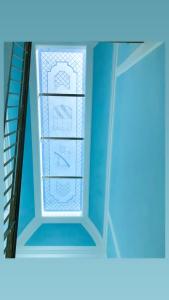 a refrigerator door with glass shelves in a room at Coco's Apartment in Meta