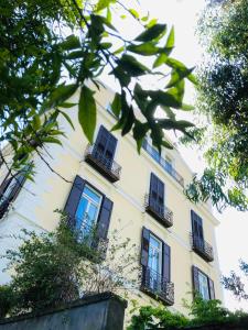 a yellow building with black windows and balconies at Coco's Apartment in Meta