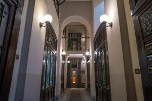 a hallway in a house with stained glass doors at ARCADIAN suite&rooms in Turin