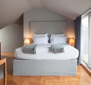 a bedroom with a large white bed with two pillows at Villa Cascais Boutique Hotel in Cascais