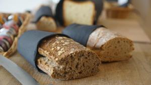a group of bread on a table with a knife at Grand Hôtel de la Poste in Saint-Jean-de-Luz