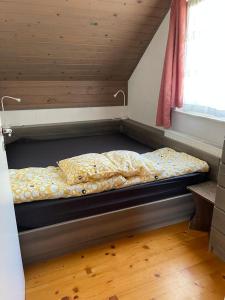 a bed in the corner of a room at Apartma Nina in Bohinj