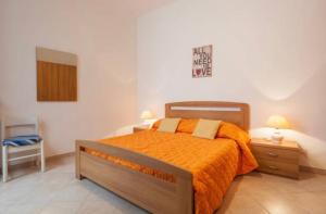 een slaapkamer met een groot bed en een oranje deken bij Arte&Musica in Verona