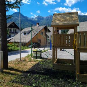 a playground with a swing set in a yard at Apartma Nina in Bohinj +14 photos