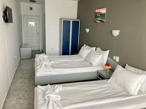 A bed or beds in a room at Plovdiv Hotel