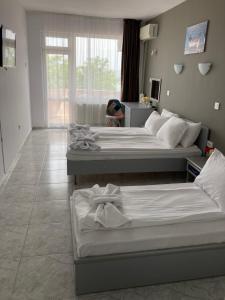 A bed or beds in a room at Plovdiv Hotel