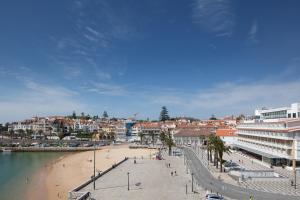 a view of a beach with buildings and a city at Villa Cascais Boutique Hotel in Cascais