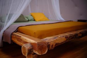 a bed made out of a wooden log at That's life Glamping - Dolomite Experience in Dorgnan