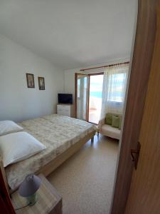 Postel nebo postele na pokoji v ubytování Apartmani Grzelj-Skledar