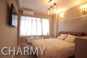 a bedroom with a large bed and a window at Live Bucharest in Bucharest