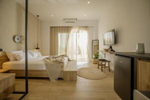 a bedroom with a bed and a table in a room at Casa Costa Suites in Kanali