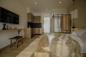 a large bedroom with a bed and a kitchen at Casa Costa Suites in Kanali