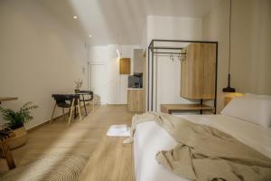 a bedroom with a bed and a dining room at Casa Costa Suites in Kanali