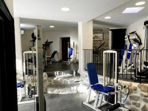 a gym with blue chairs and exercise equipment at Les Terres Rouges 06 in Guillaumes