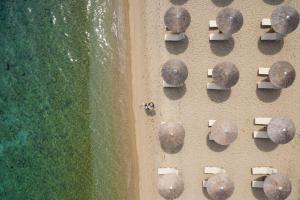 an aerial view of chairs and umbrellas on a beach at Kassandra Palace Seaside Resort in Kriopigi