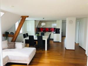 a living room with a white couch and a table at Apartment auf dem Bauernhof in Luzern