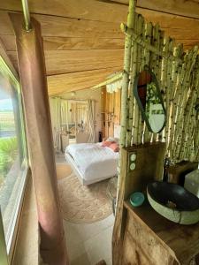 a bathroom with a sink and a bed in a room at Le p'tit nid de Gabriel in Les Touches-de-Périgny