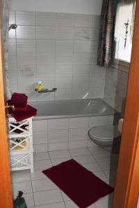 a bathroom with a tub and a toilet at Geniessen Sie die Ruhe und den Seeblick 