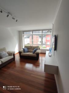 a living room with a couch and a table at Apartamento Paula in Cee