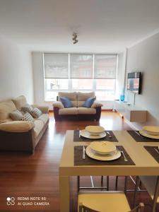 a living room with a couch and a table at Apartamento Paula in Cee