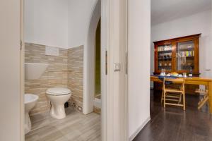 a bathroom with a toilet and a sink and a desk at Penelope Holiday in Rome +133 photos