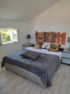 a white bedroom with a large bed with pillows at Appartements Dominique, with private terrace in Supetarska Draga