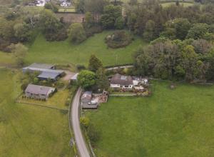 an aerial view of a house on a green field at Padog B&B in Llanrwst