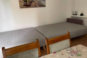a bedroom with two beds and a table and chairs at Apartament Seagull 30m2 (300 meters to the sea) in Hel