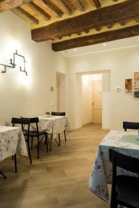 a dining room with tables and chairs and wooden floors at Acquerello in San Quirico dʼOrcia