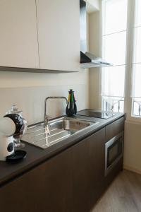 a kitchen with a sink and a counter top at Acquerello in San Quirico dʼOrcia
