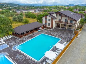 an aerial view of a house with a swimming pool at Sofion hotel&resort in Solotvyno