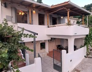 an external view of a house with a balcony at SYNNEFO - Home in the clouds in Exanthia
