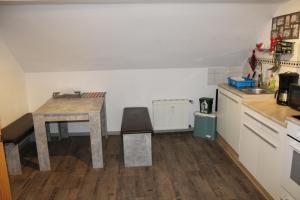 a kitchen with a desk and a table in a room at Grüner Blick in Witten +29 photos
