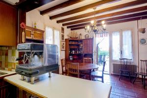 a kitchen with a sewing machine on a counter at Villa Tamagna - Swimming Pool, Barbeque, Garden in Bevera