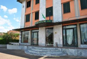 a building with a sign on the front of it at Hotel Sextum in Bientina