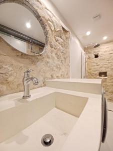 a bathroom with a sink and a mirror at SYNNEFO - Home in the clouds in Exanthia +37 photos