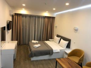a hotel room with a bed and a desk at panorama beach tower in Batumi