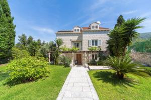 an exterior view of a house with a garden at Villa Jolanda Apartments in Dubrovnik