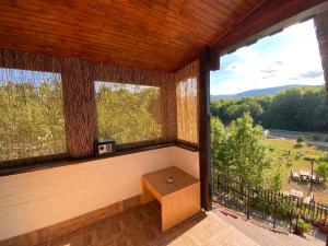 a screened in porch with a table and two windows at Apartment Ivanka in Rastovača