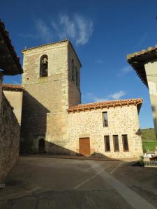 a large brick building with a clock tower on it at Casa Perazancas At 34-49 in Perazancas