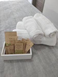 a tray of towels and books on a bed at B&B Domus Piedigrotta in Pizzo