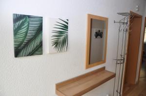 três imagens penduradas numa parede ao lado de um espelho em Ferienwohnung Schöne Zeit em Gedern
