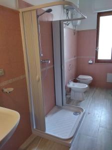a bathroom with a shower and a toilet at Orchidea House in SantʼAntìoco