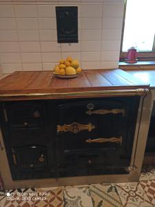 an old cabinet with a bowl of fruit on top of it at CASA DA LOAIRA in Quiroga
